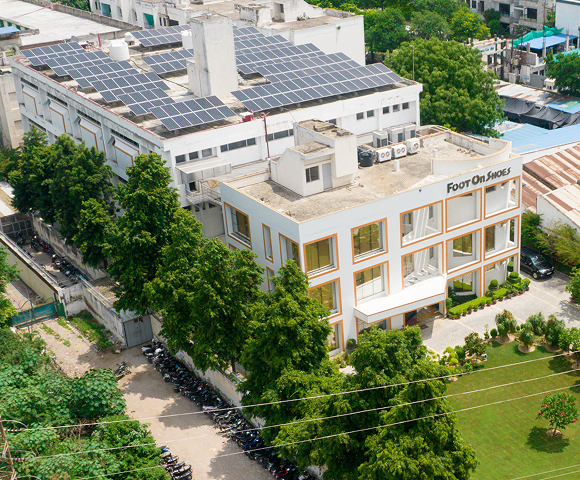 Aerial view of the Foot On Shoes factory in Agra, with solar panels across the roof