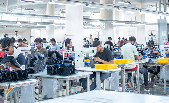 Stitching floor at the Foot On Shoes factory with operators at work