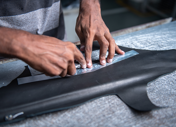 Operator marking and cutting leather panels for boot uppers