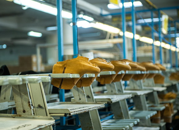 Leather boot uppers on racks along the Foot On Shoes production line
